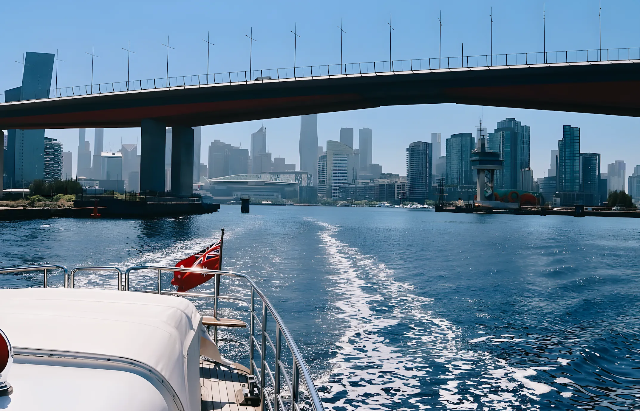 View aft from Elizabeth Anne underway on the Yarra, her wake and red ensign against the skyline