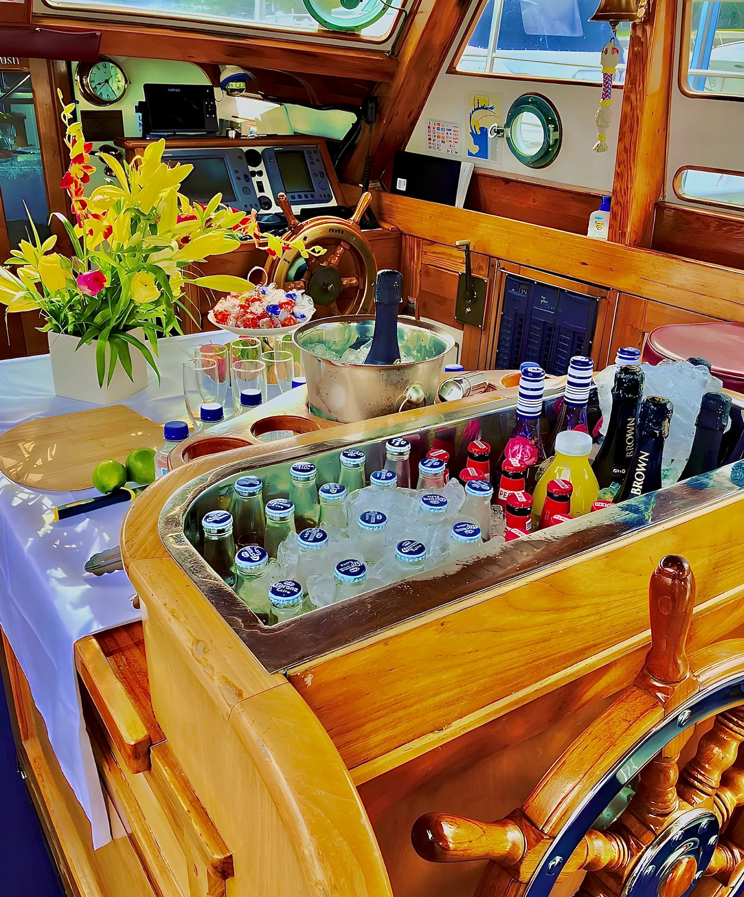 The wheelhouse bar dressed for the day — fresh flowers, champagne on ice and glassware ready
